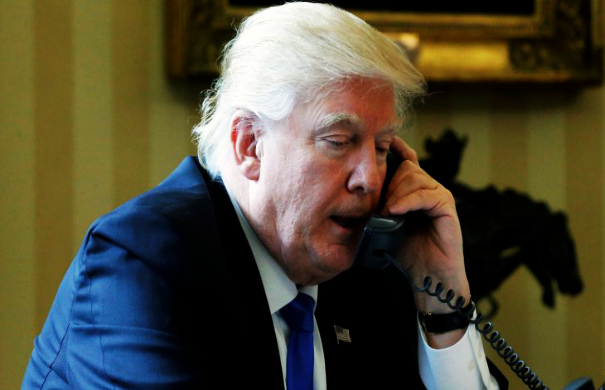 U.S. President Donald Trump speaks by phone with Russia's President Vladimir Putin in the Oval Office at the White House in Washington, U.S. January 28, 2017. REUTERS/Jonathan Ernst